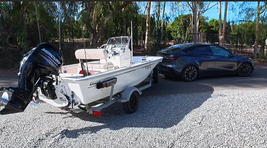 The Montauk 150 on its trailer behind a Tesla Model Y