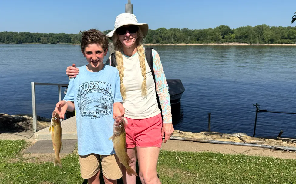 Ericka and Dylan holding walleye on the Mississippi River